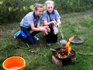 Hanney Guides lighting a camp fire.